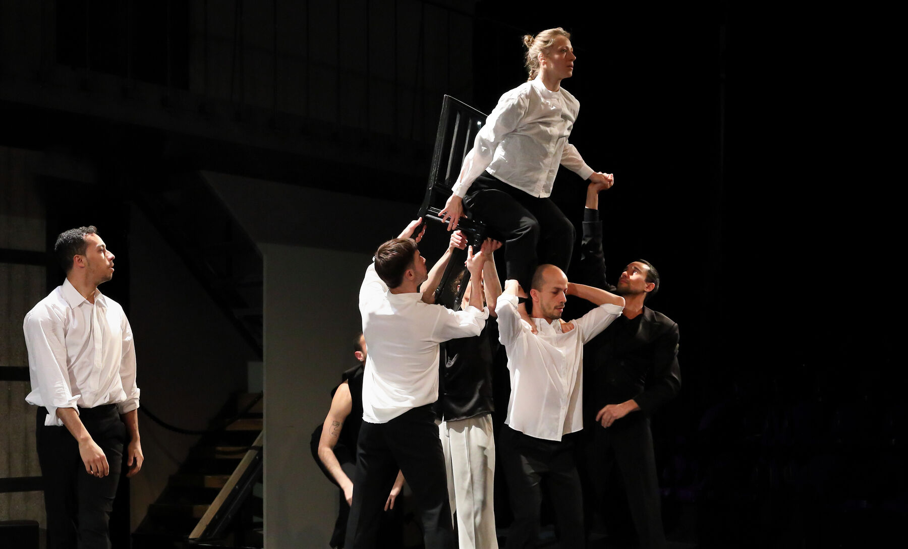 Dancers, dressed in black and white, can be seen.