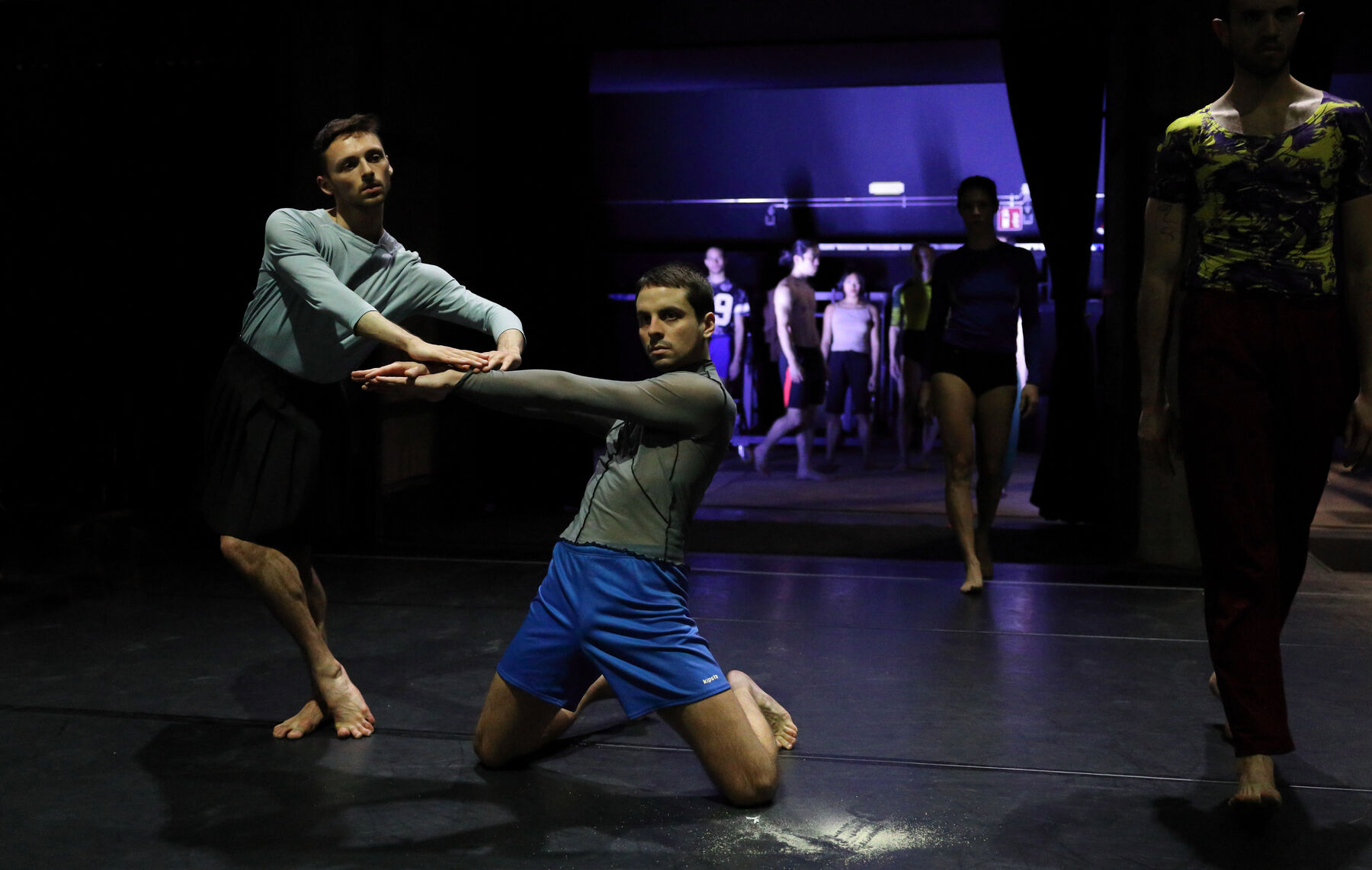 Dancers can be seen on a stage.