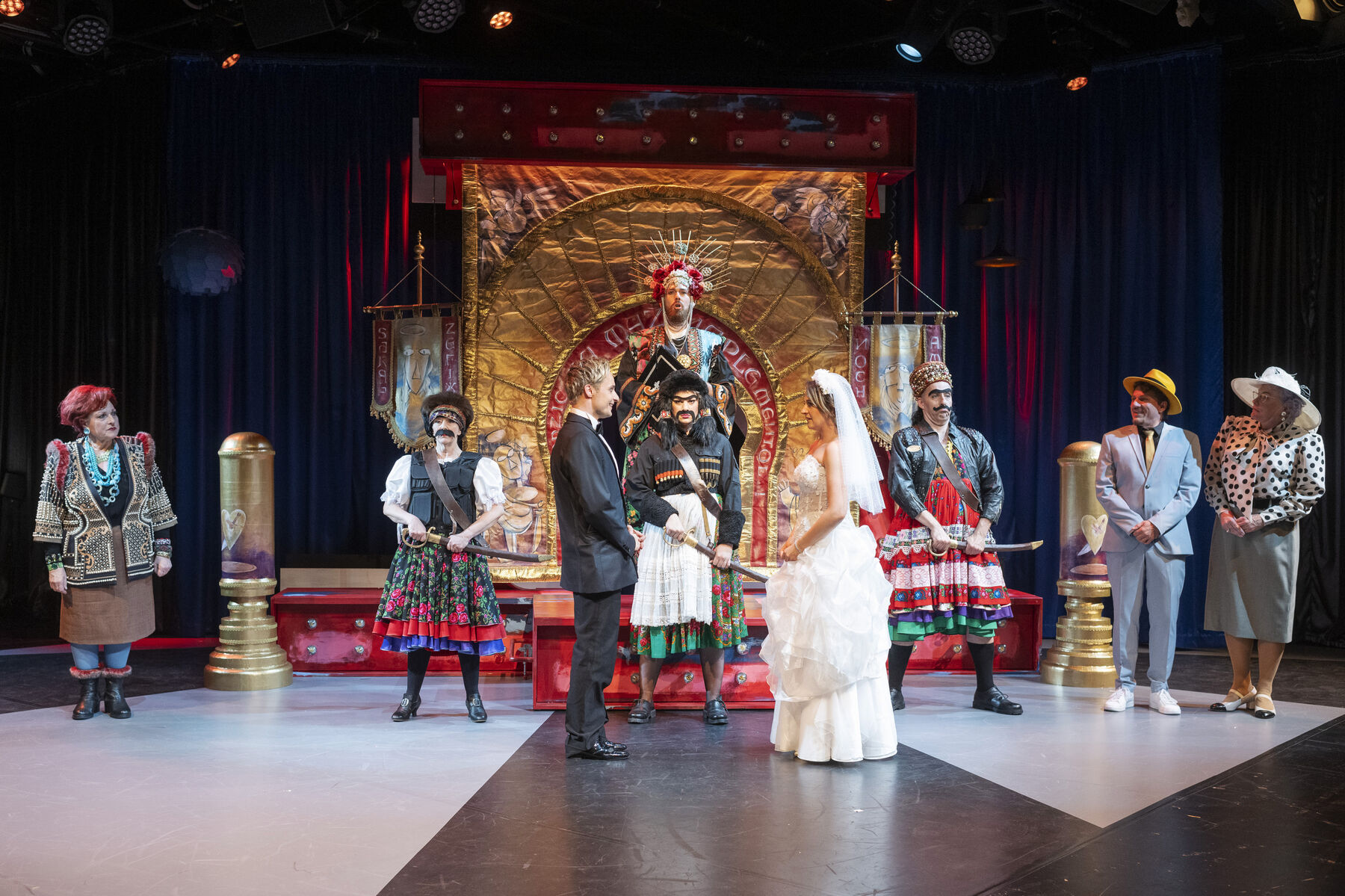 A man and a woman in wedding attire stand opposite each other in front of an altar. A small wedding party stands around them. Soldiers stand in front of the altar and a priest. 
