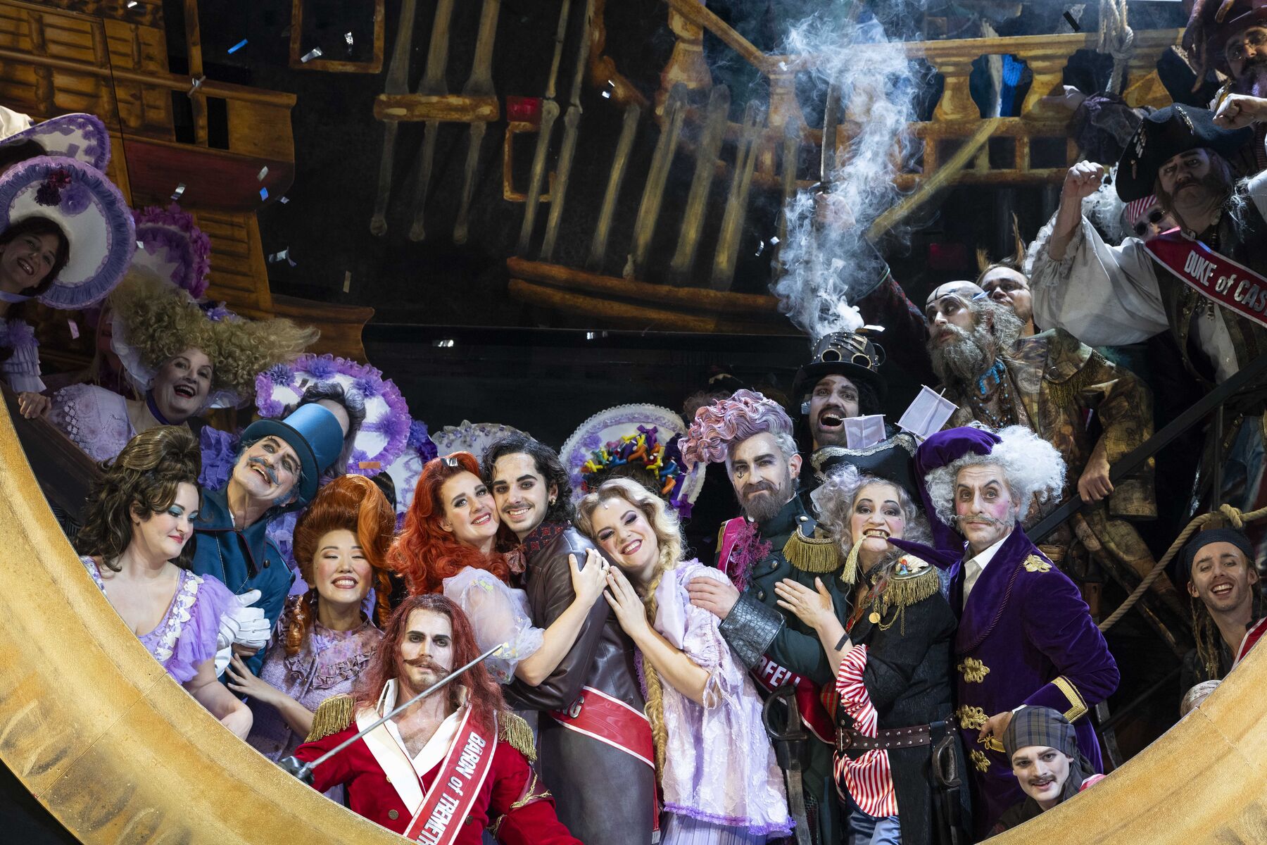 Everyone looks through a large porthole and is happy. Frederic holds his Mabel in his arms. Only the pirate king looks serious.